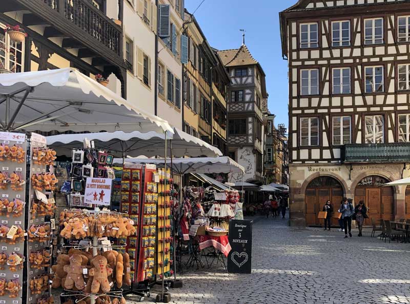 Calles adoquinadas, casas antiguas, tiendas de souvenirs en Estrasburgo, Alsacia